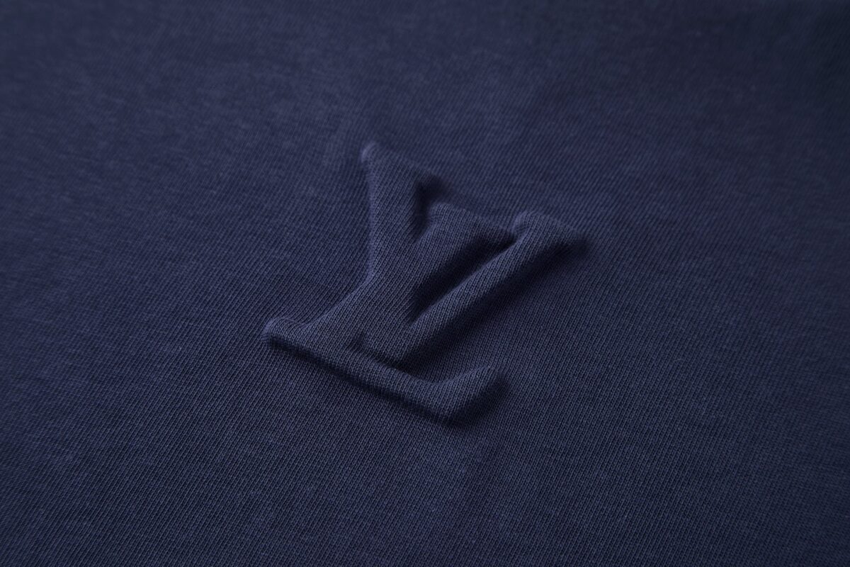 P110 LOUIS VUITTON 压花标识短袖 面料：采用32支双纱精梳棉。 面料：螺纹采用1*1配套索罗娜。 工艺：原版定制1：1LV标识压花模具，同比例尺寸与厚薄度。 本款T恤取材柔软棉布针织，以品牌元素点亮经典设计。肩头缝线和背后的桑蚕丝嵌花标签呈现内外翻转效果，硅质LV标识刺绣再添品牌格 调。 辅料：定制1：1洗水商标 辅料：定制1：1压花标识 尺码：S-M-L-XL 颜色：黑-白-蓝-紫-宝蓝-灰 款号：86224-818
