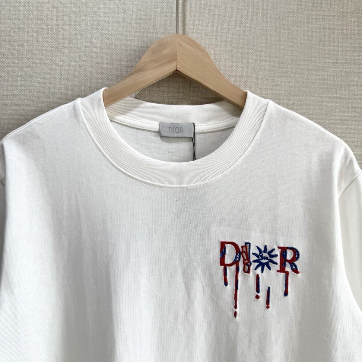 P75 款号TM1068 Dior 迪奥红标涂鸦太阳刺绣圆领短袖 面料：280克32支双纱纯棉面料 工艺：重工精梳棉 螺纹同缸同色 整体不会有色差 当下热度爆款 男女情侣款 定制原版一致辅料 三标齐全 os宽松版型 最大可穿到200斤左右 颜色：黑色 白色 尺码：S M L XL