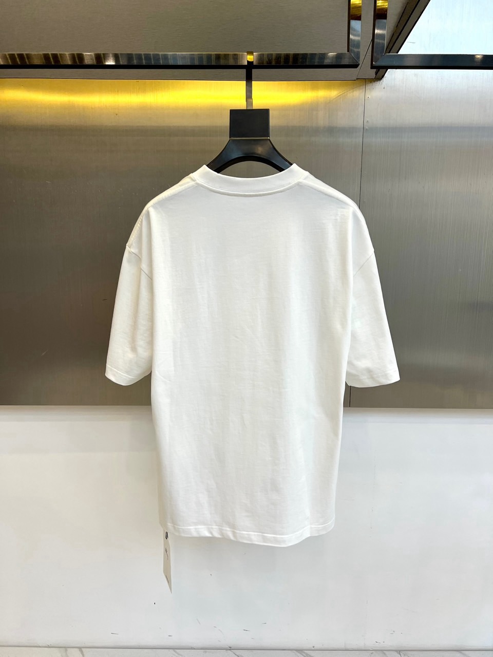 weigou_189753_6_7855439801 P75 爱马仕 2026春夏新品经典短袖T恤,延续品牌标志性的简约美学与法式松弛感,以纯色为底色,左胸点缀小巧精致刺绣,精致不张扬,诠释低调高级的都市格调。宽松廓形剪裁,落肩设计搭配微阔下摆,包容各种身形,营造随性自在的穿着体验,无论是单穿还是叠搭皆能轻松驾驭。面料甄选高支棉质,触感柔软亲肤,透气性佳,适合春夏日常通勤、周末出游或轻社交场合。极简线条与自然垂坠感赋予衣身流动韵律,细节处彰显匠心工艺,下摆保留原厂吊牌,传递新品首发质感。这款T恤不仅是衣橱基础款,更是风格表达的点睛之笔——不喧哗,自有声。2026春夏,让爱与自由在衣襟间悄然绽放,穿出属于你的温柔力量与都市从容。S- XXL(模特173,140斤上身M码)