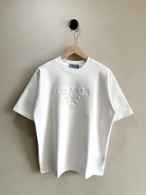 weigou_197972_0_58e1200595 P70 款号TM1074 普拉达 PRADA 夏季经典胸前钢印logo圆领短袖 面料:300克32支双纱纯棉面料 工艺:重工精梳棉 螺纹同缸同色 整体不会有色差 当下热度爆款 男女情侣款 定制原版一致辅料 三标齐全 os宽松版型 最大可穿到200斤左右 颜色:白色 黑色 尺码:S M L XL