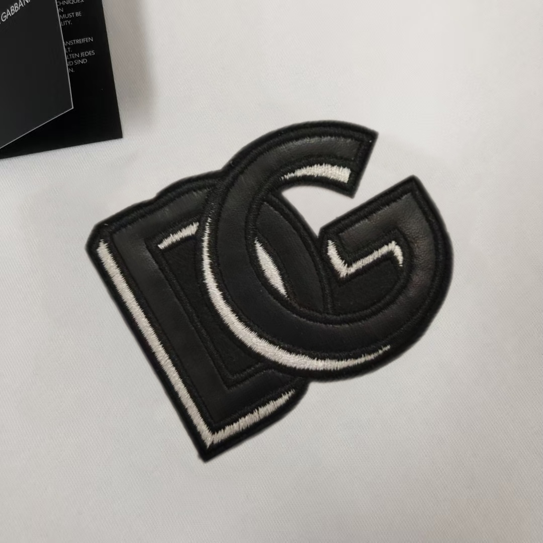 P75 Dolce&gabbana 专柜同款圆领短袖T恤 定制棉质面料 ！采用品牌DG Logo标志皮牌设计！ 立体感强！使整体高透气和柔软性的质感更加凸显，饱满的棉质感引起极度舒适。高端人士必备单品，原厂辅料三标齐全！男女同款！ 颜色：黑色 白色 尺码：S-xxL