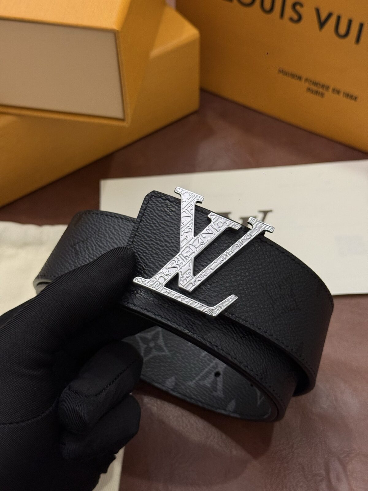 P145 本款 LV Initiales Monogram Midnight 40 毫米双面腰带精妙演绎品牌标识。双面帆布分别晕染不同色调。亮泽搭扣衬托隽永配色与经典图案的雅致蕴意。