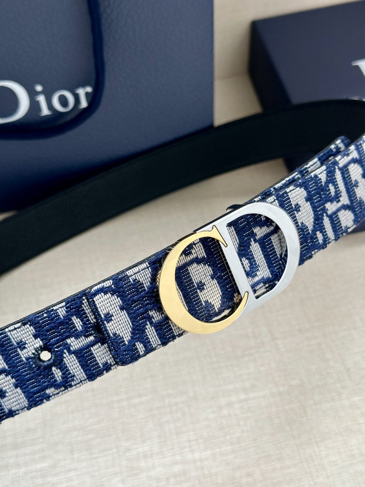Dior 新款单品，延续经典设计，饰以 CD Icon 标志。光金和白色金属覆层形成鲜明的对比。可与各式 35 毫米腰带搭配，提升格调，打造优雅精致的造型。 /